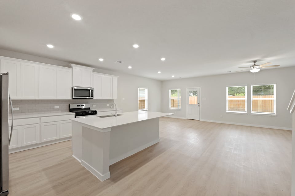 A kitchen with white cabinets.