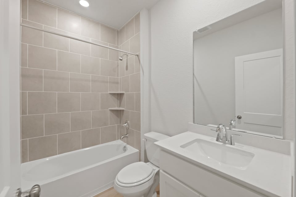 A bathroom with a sink toilet and bathtub.