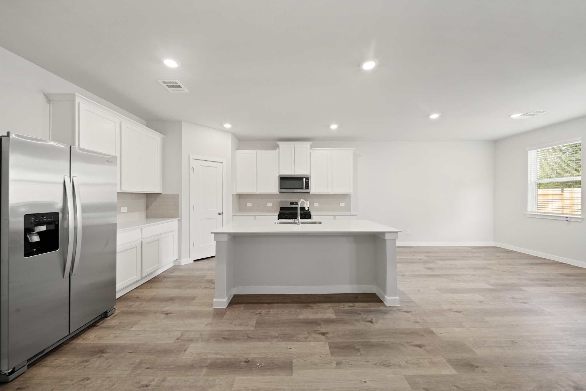 A kitchen with white cabinets.