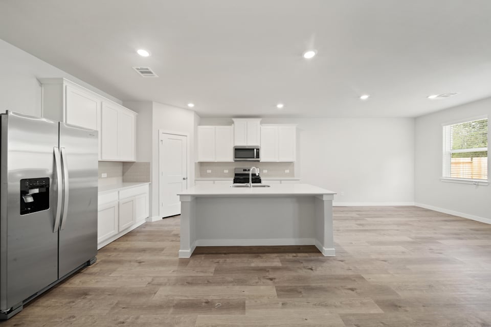 A kitchen with white cabinets.
