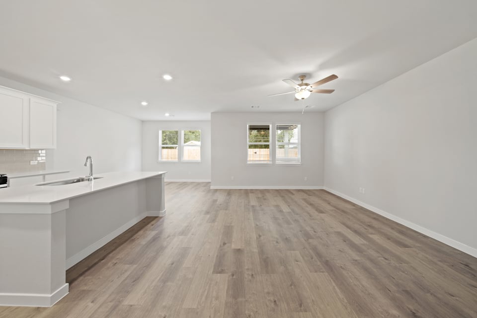 A kitchen with a wood floor.