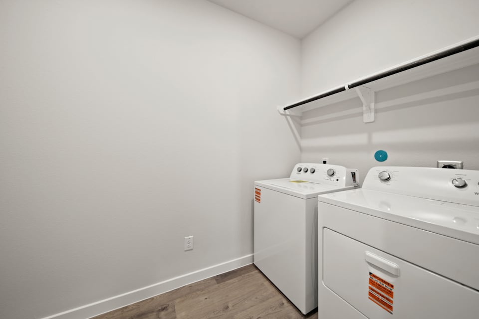 A white room with a washer and dryer.