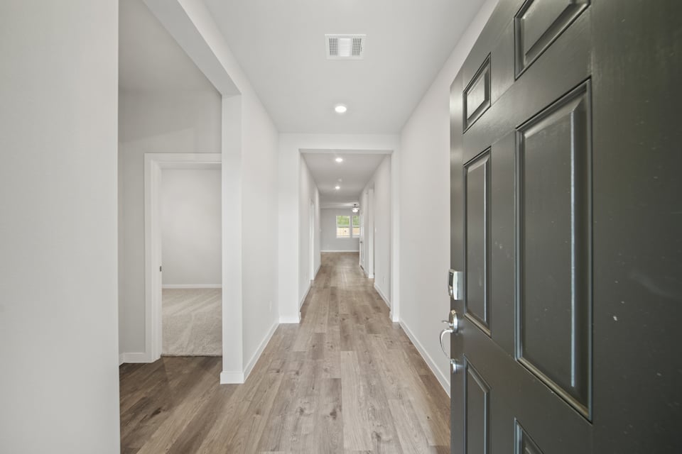 A hallway with black doors.
