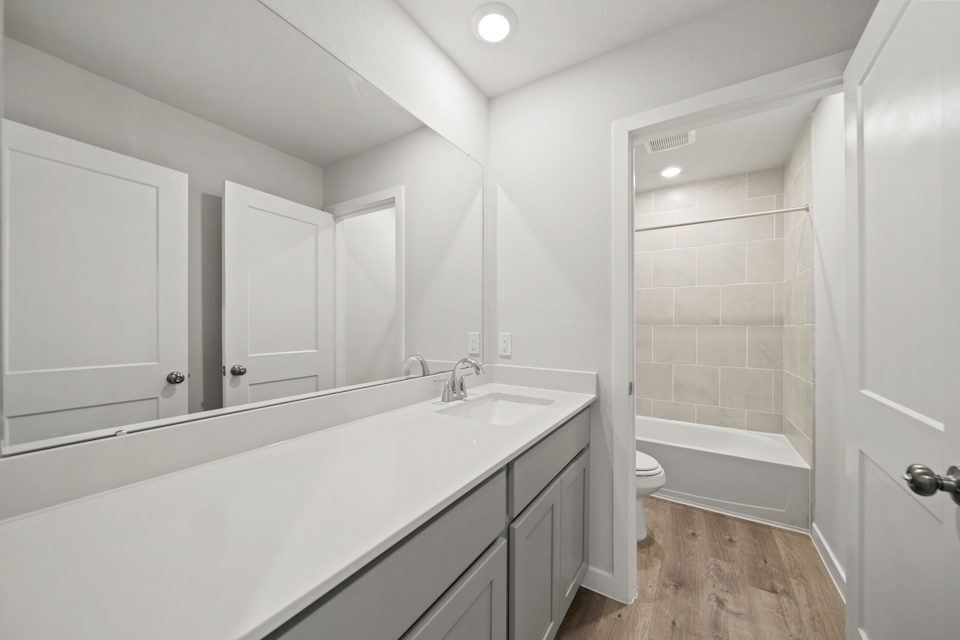 A bathroom with a tub and sink.