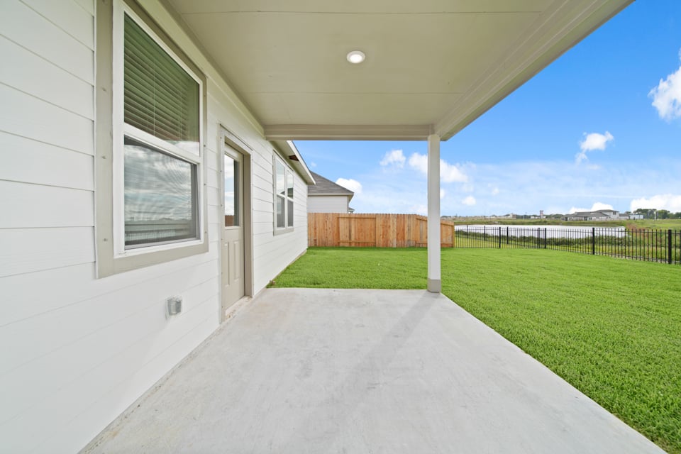 A house with a fence and grass.