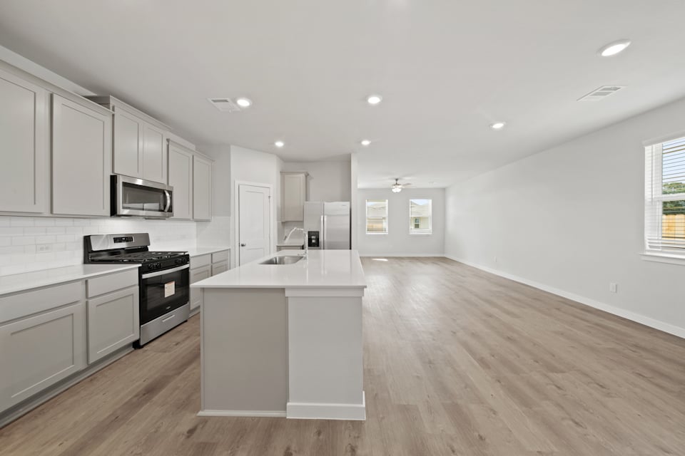 A kitchen with white cabinets.