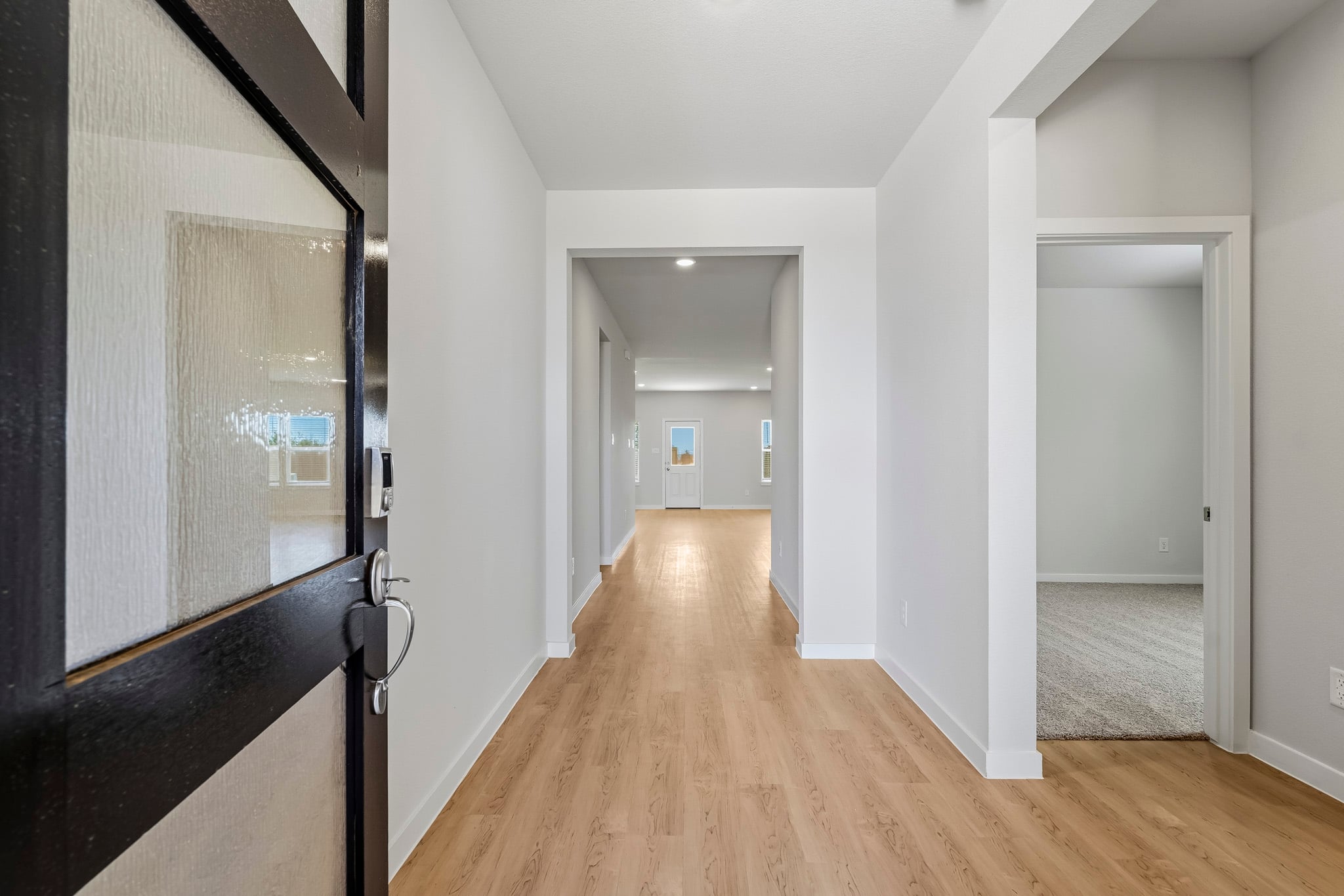 A hallway with a wood floor.