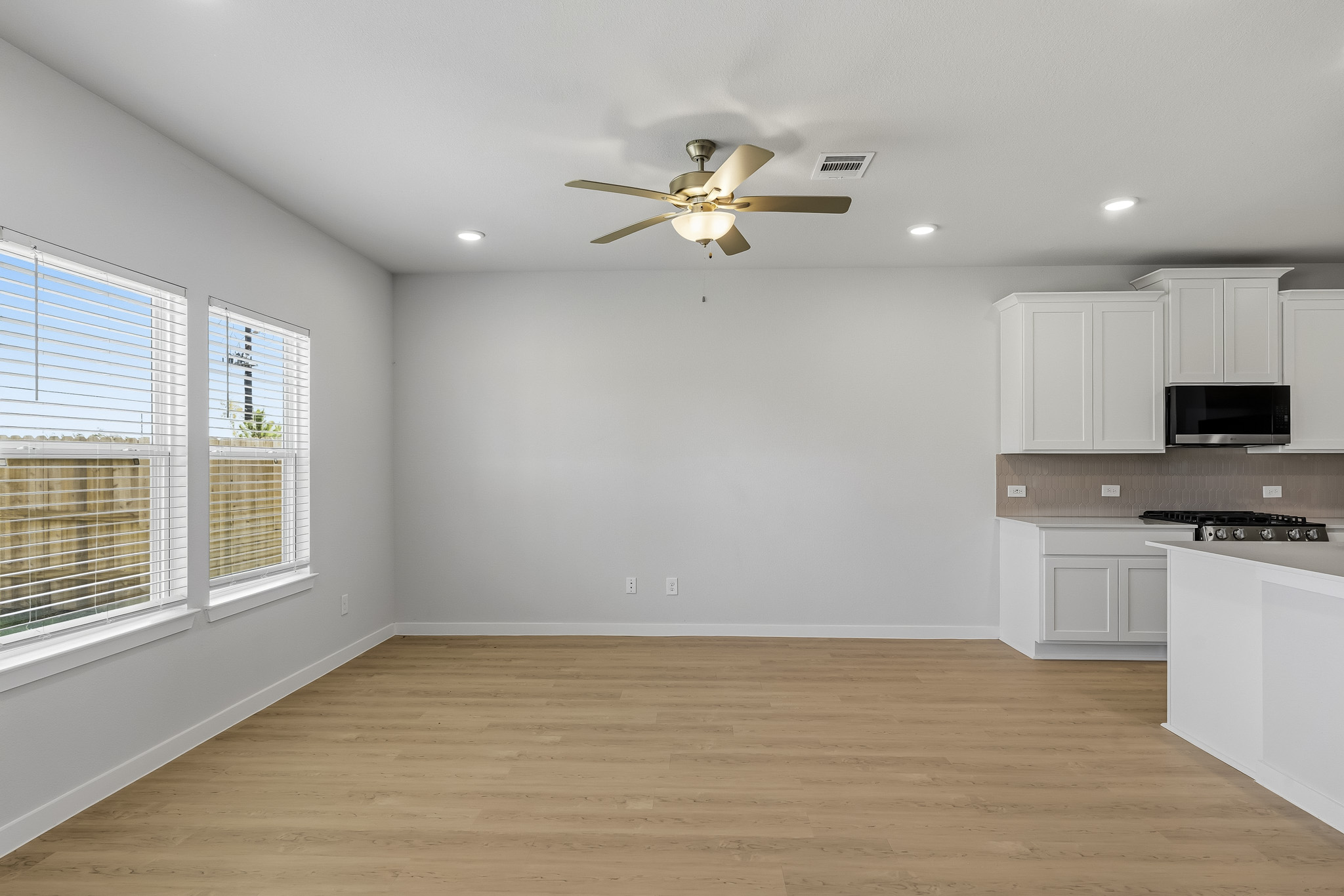 A kitchen with white cabinets.