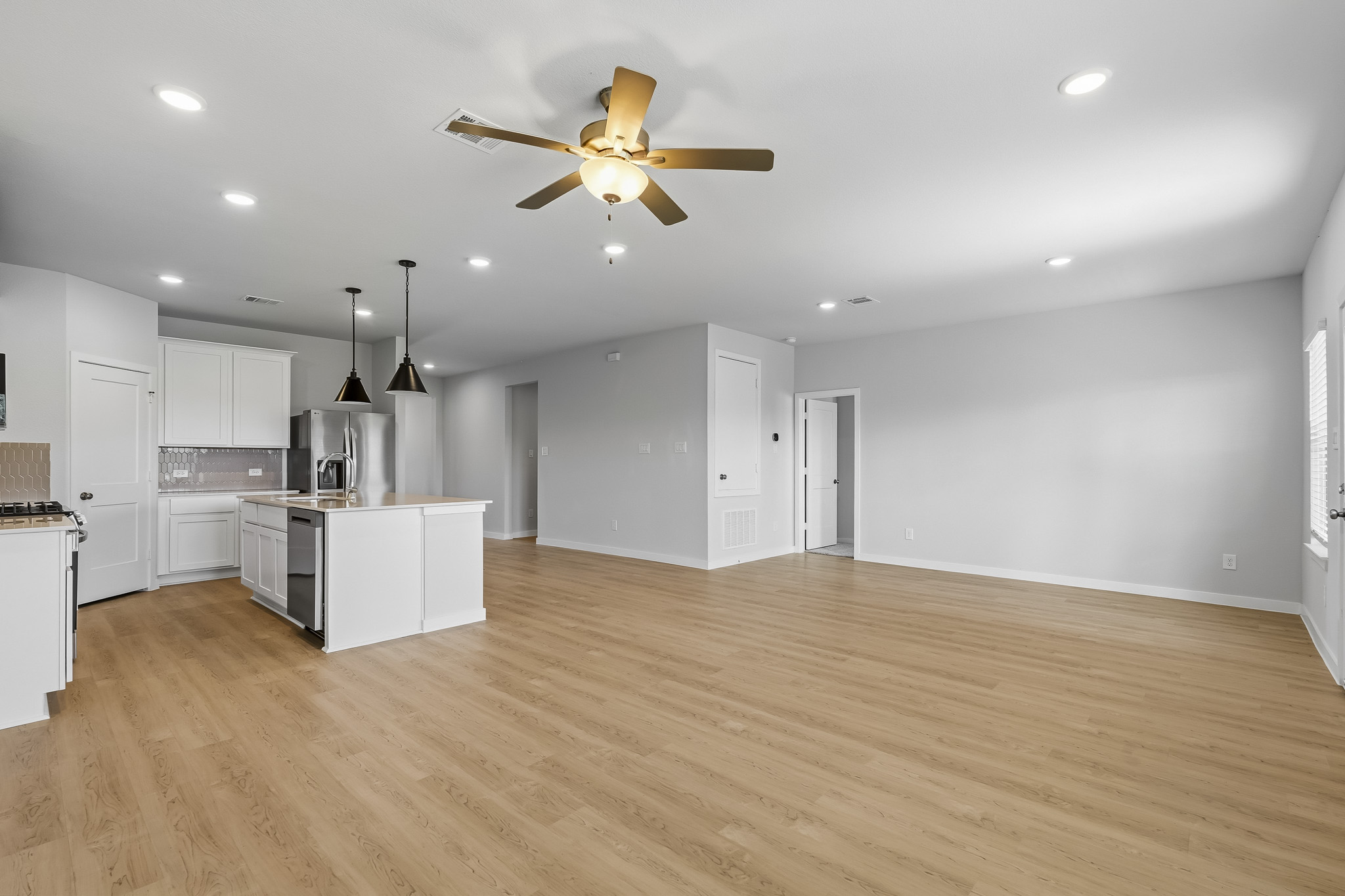 A large kitchen with white cabinets.