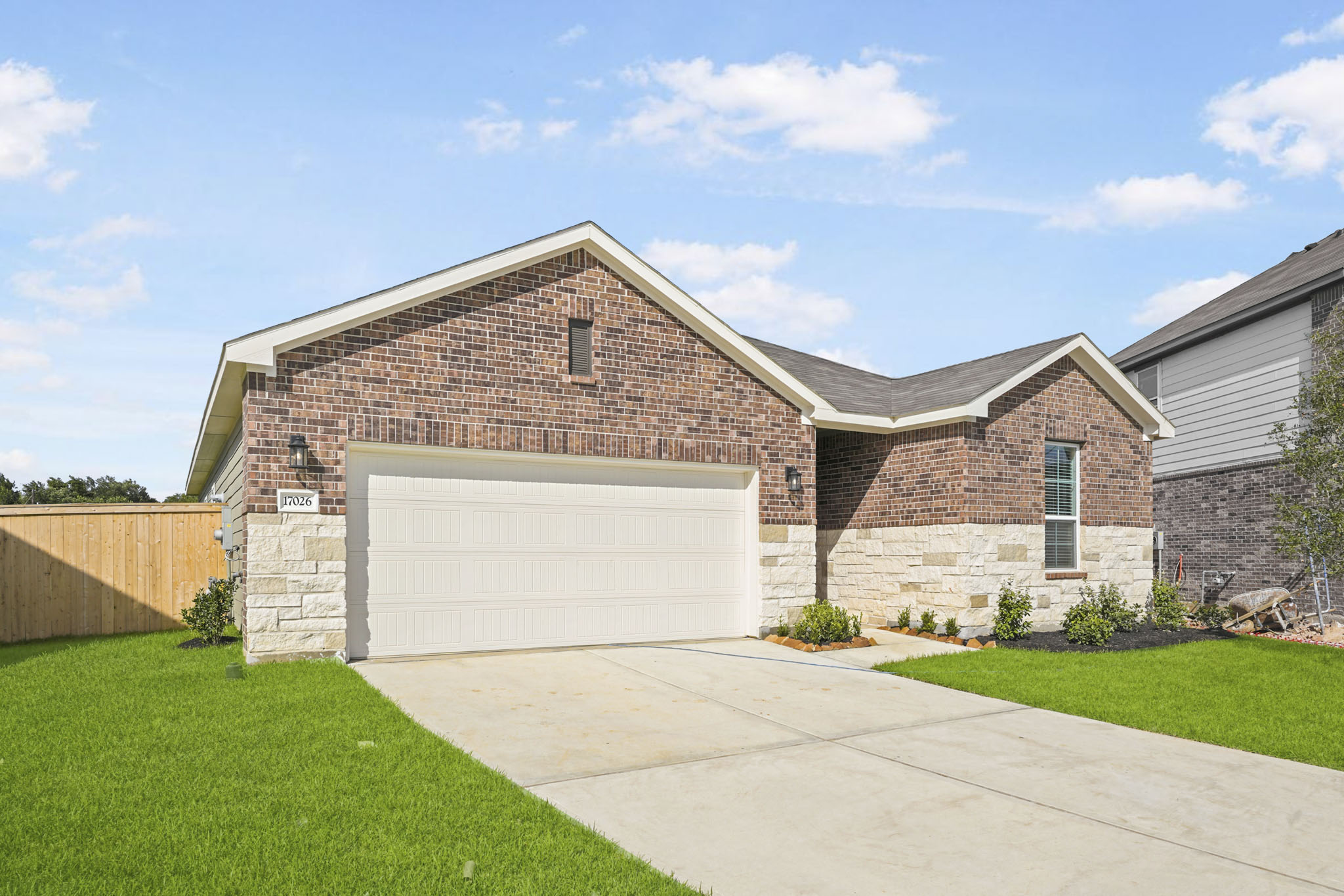 A brick house with a garage.