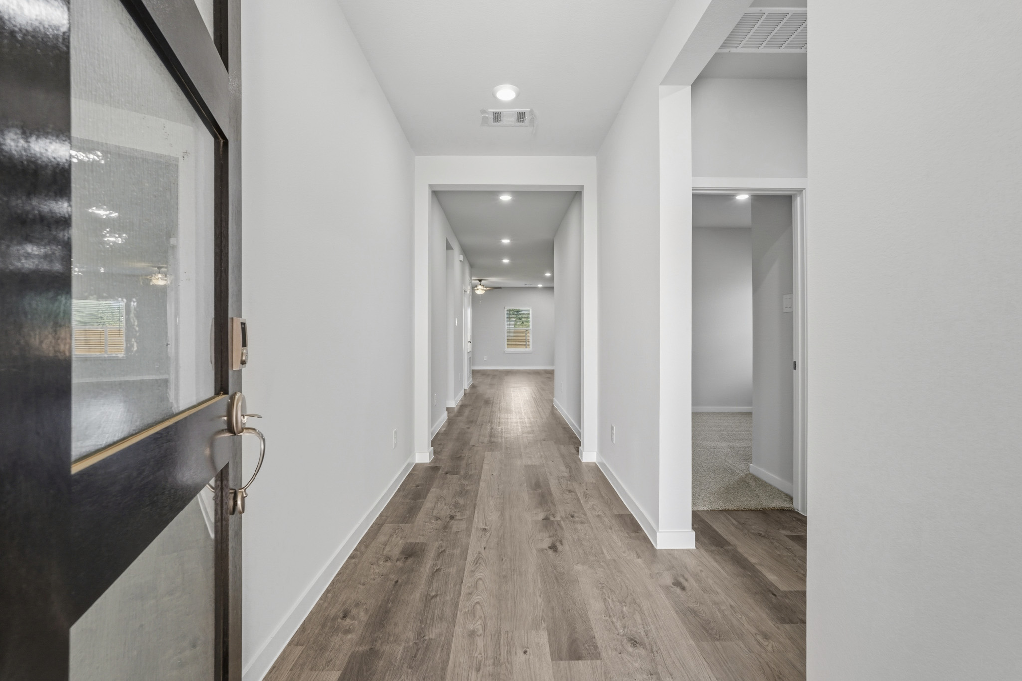 A hallway with white walls.