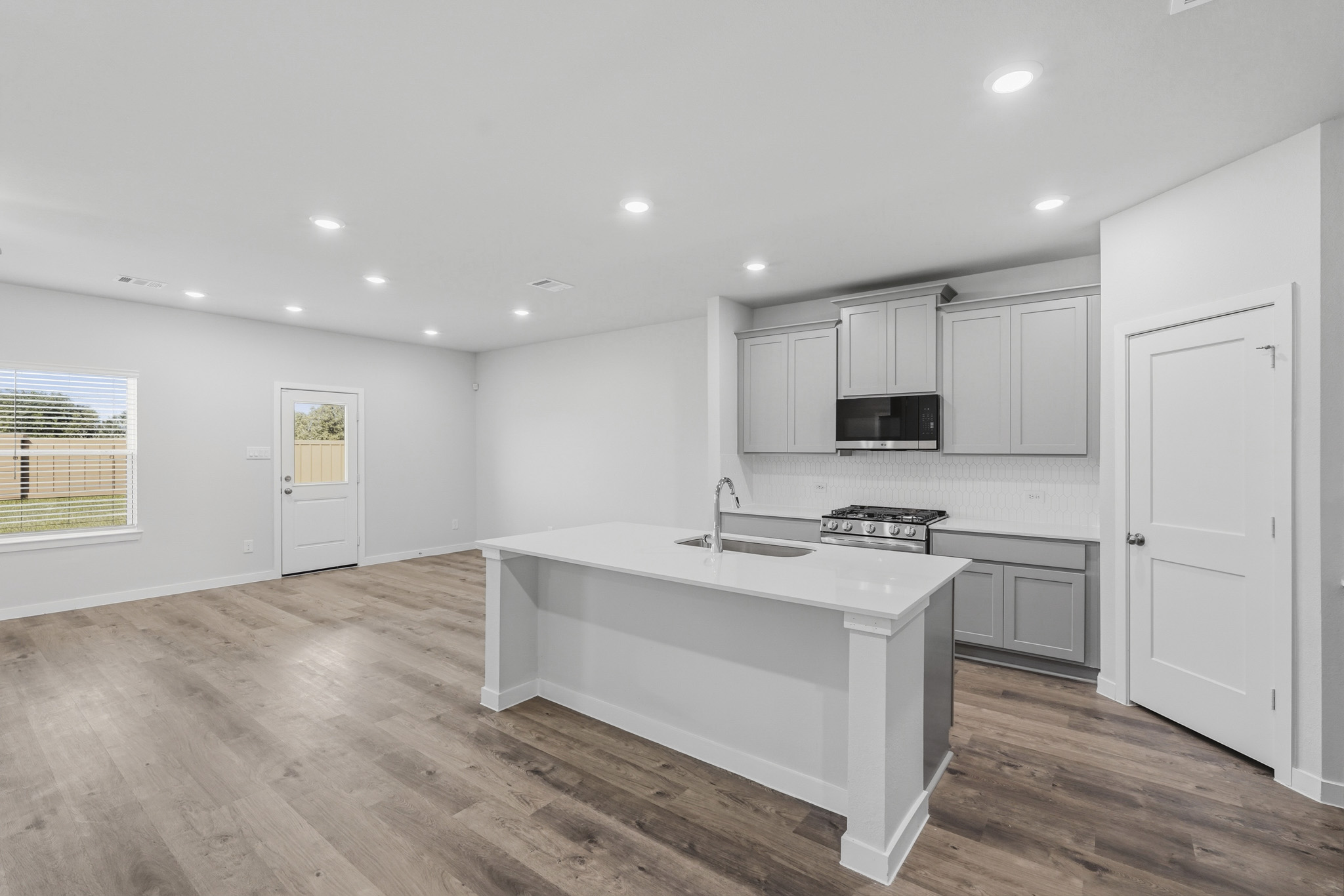 A kitchen with white cabinets.