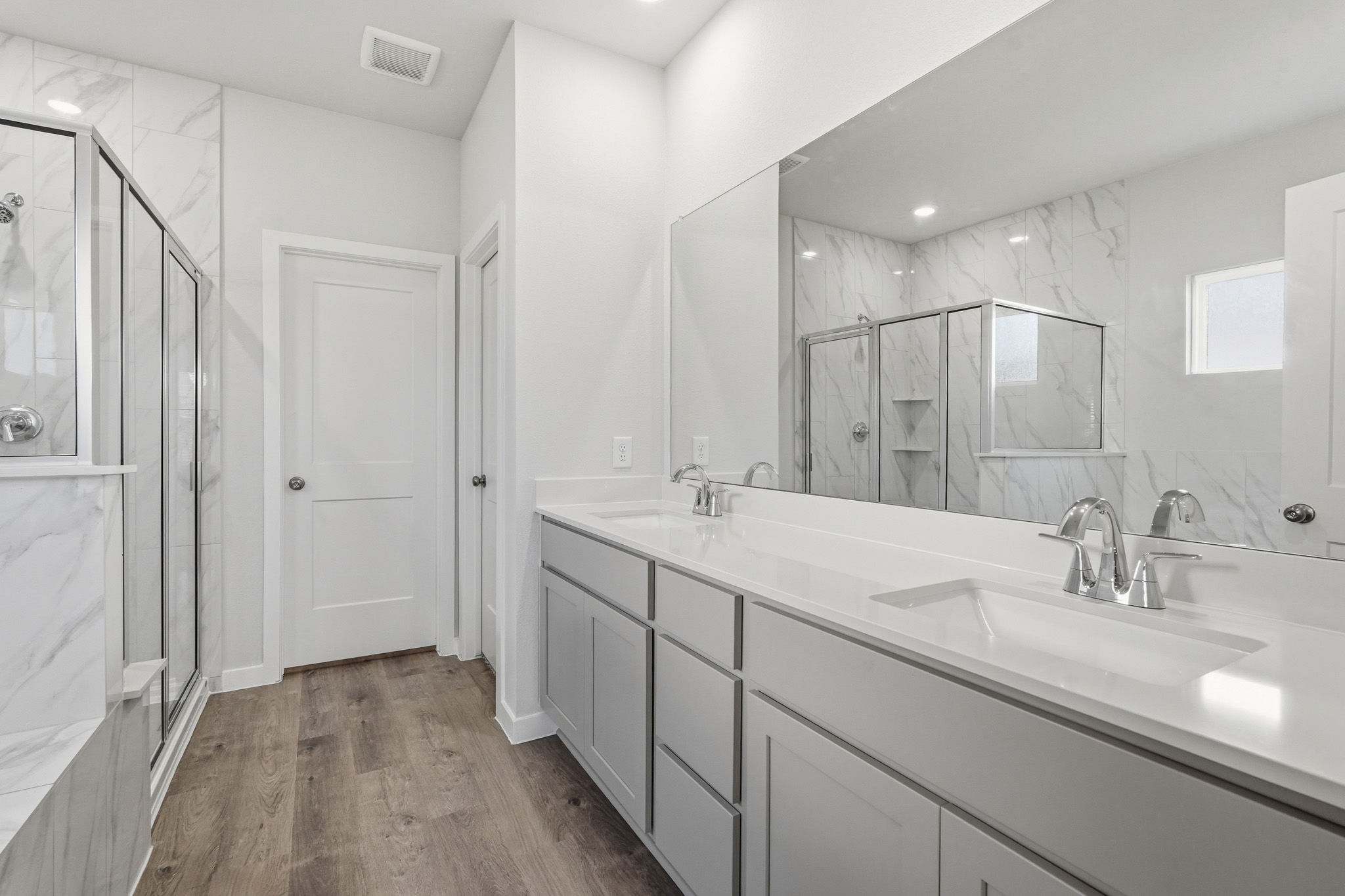 A bathroom with a large mirror.