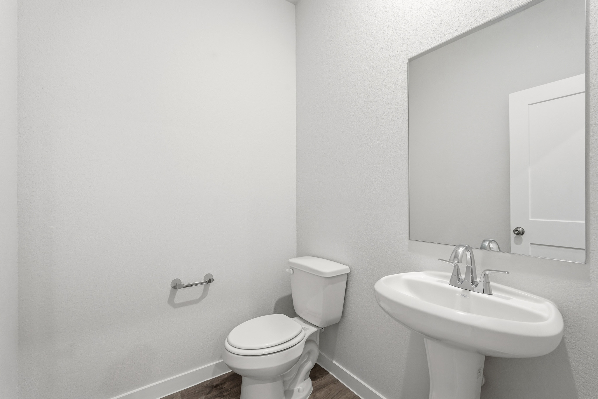 A bathroom with a toilet and sink.