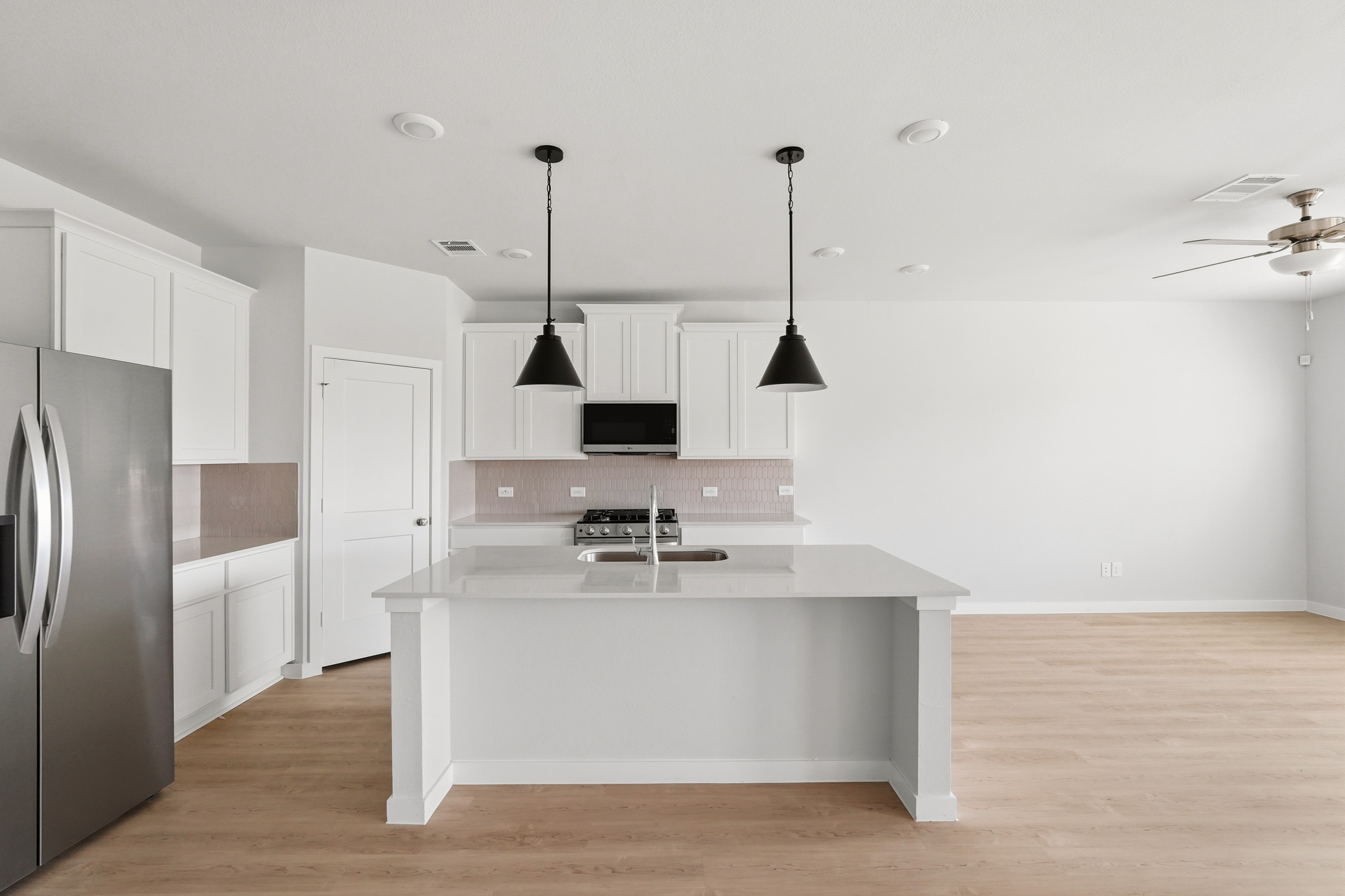 A kitchen with white cabinets.