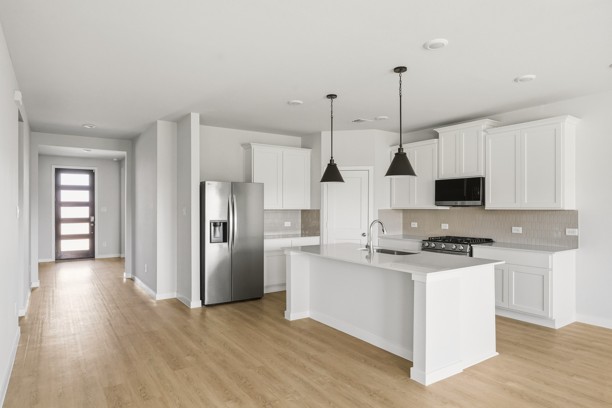A kitchen with white cabinets.