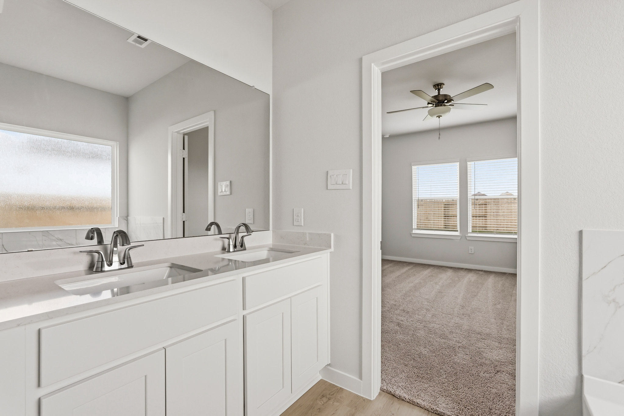 A bathroom with a large mirror.