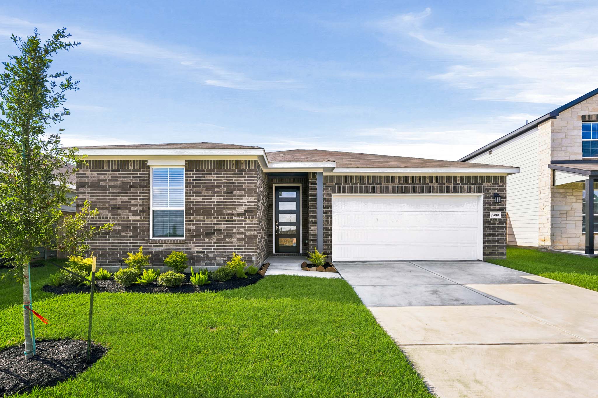 A brick building with a garage.