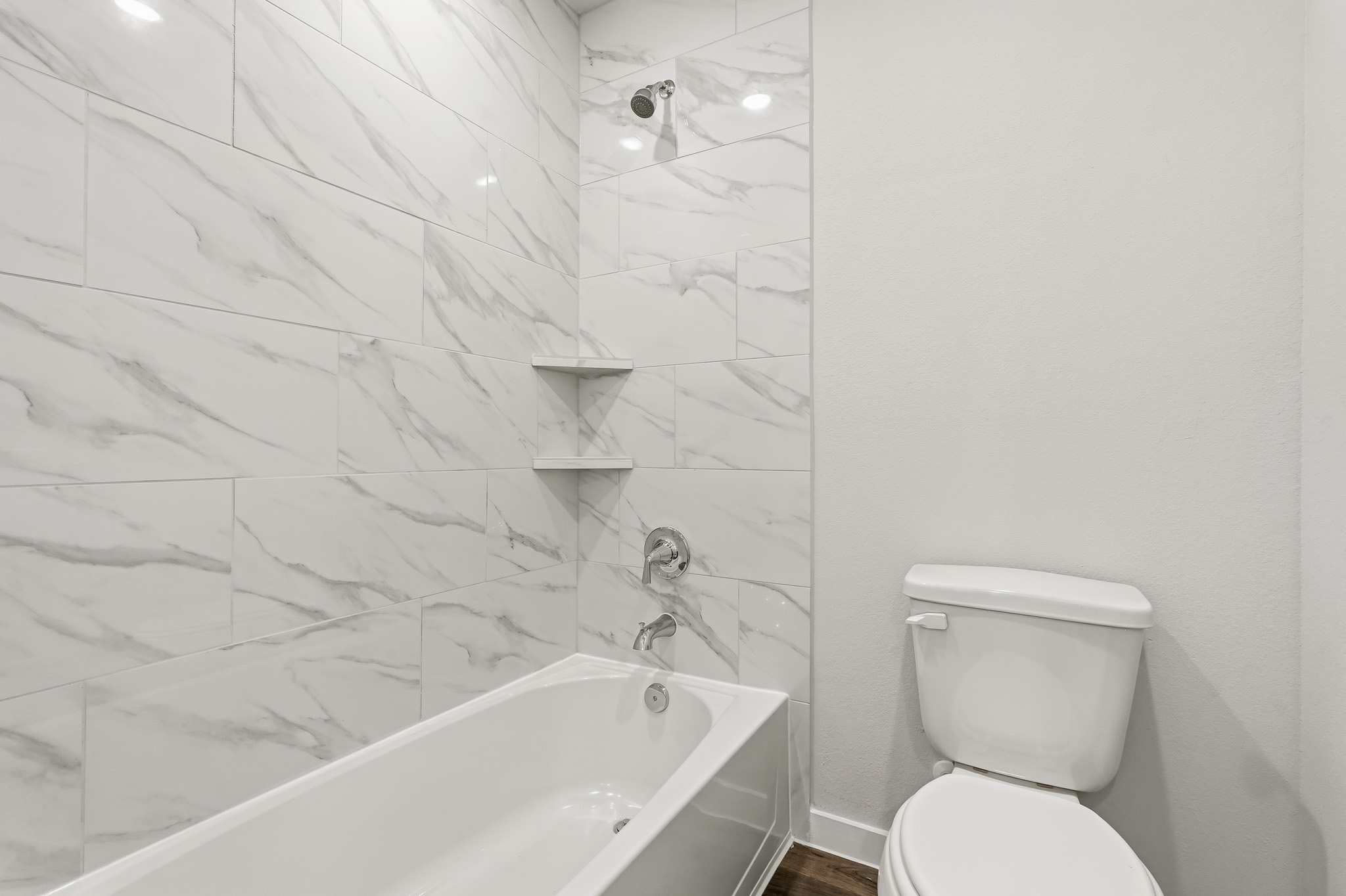 A bathroom with a tub toilet and sink.