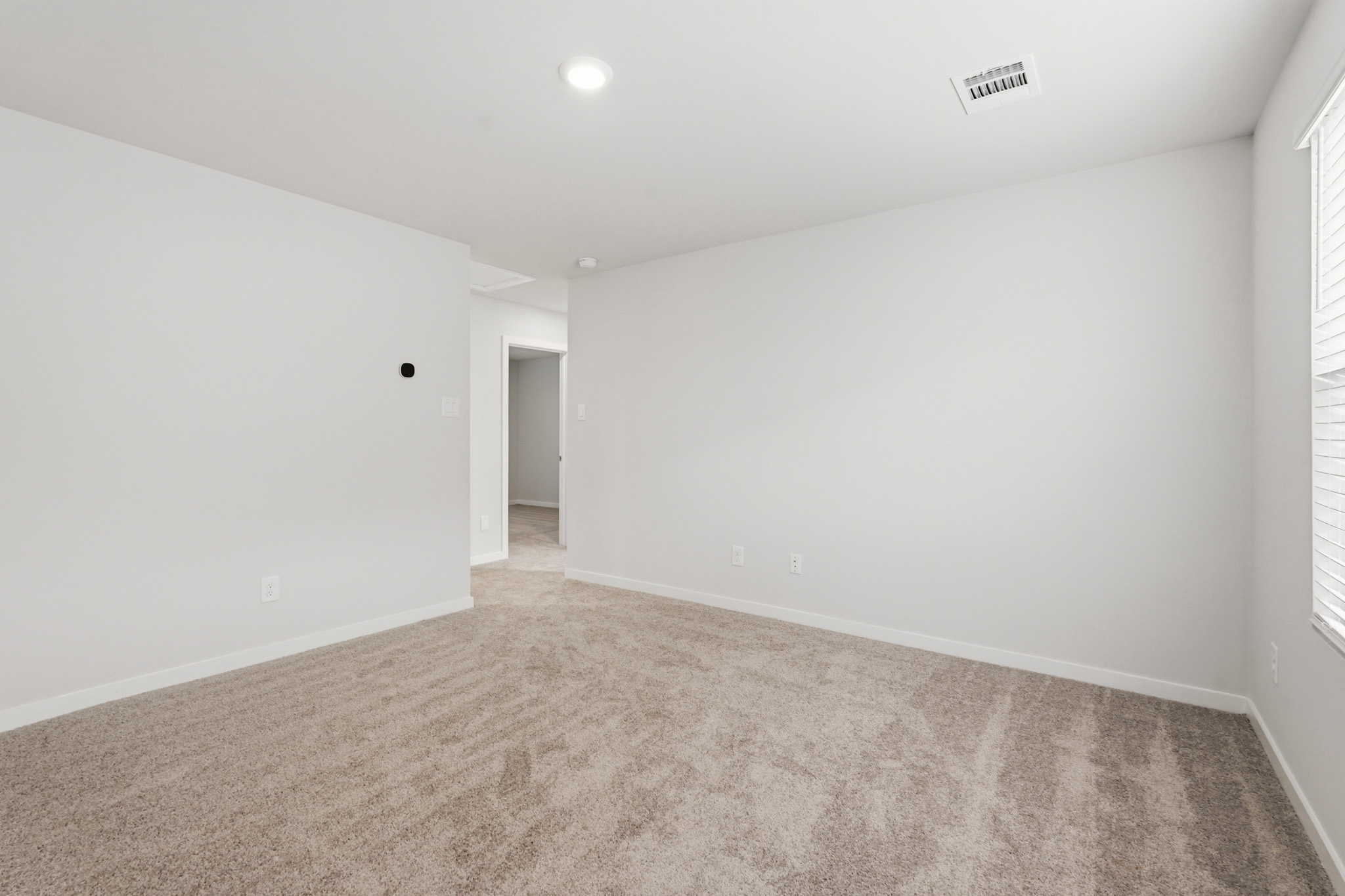 A hallway with carpet.