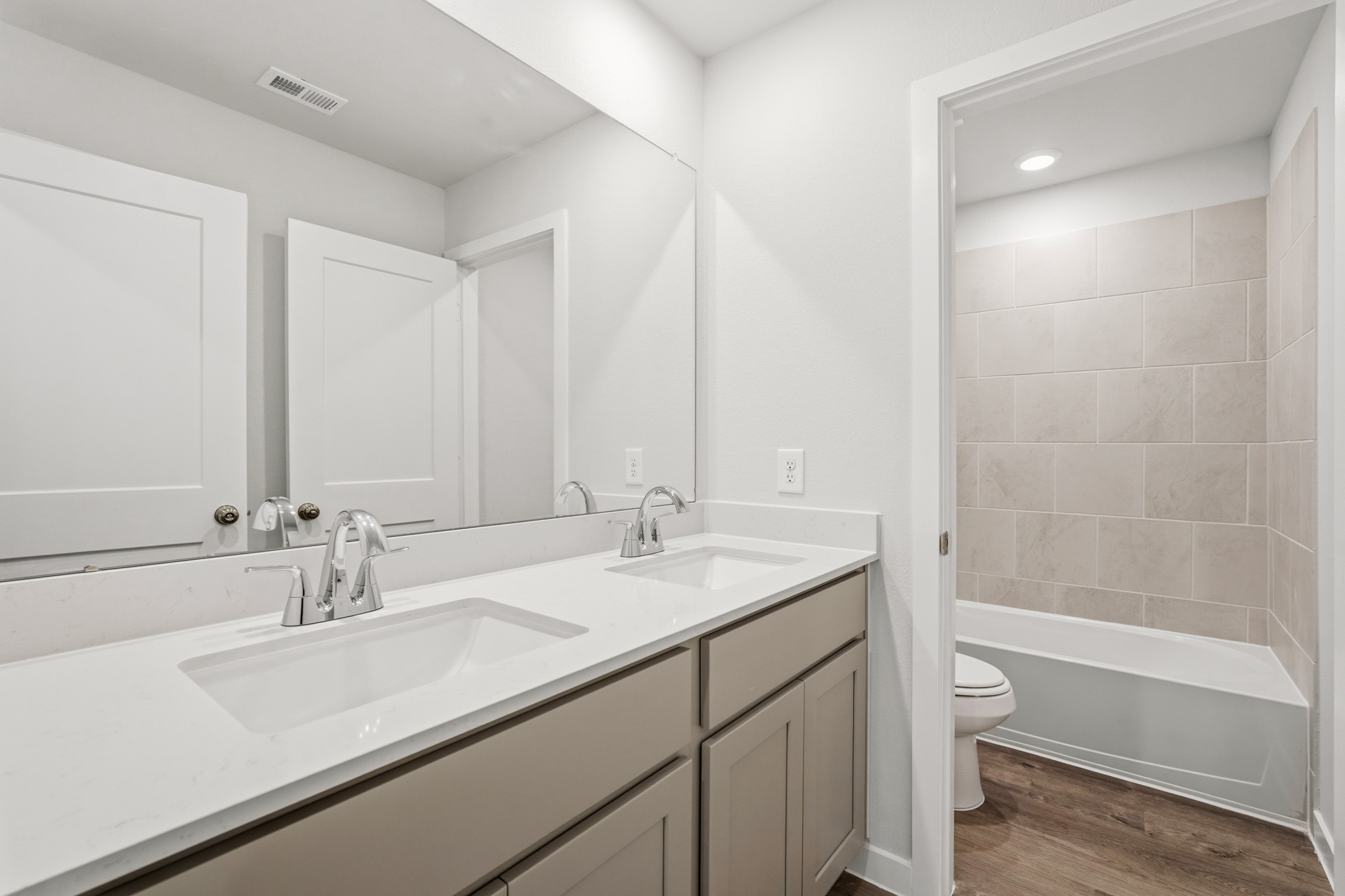 A bathroom with a tub sink and toilet.