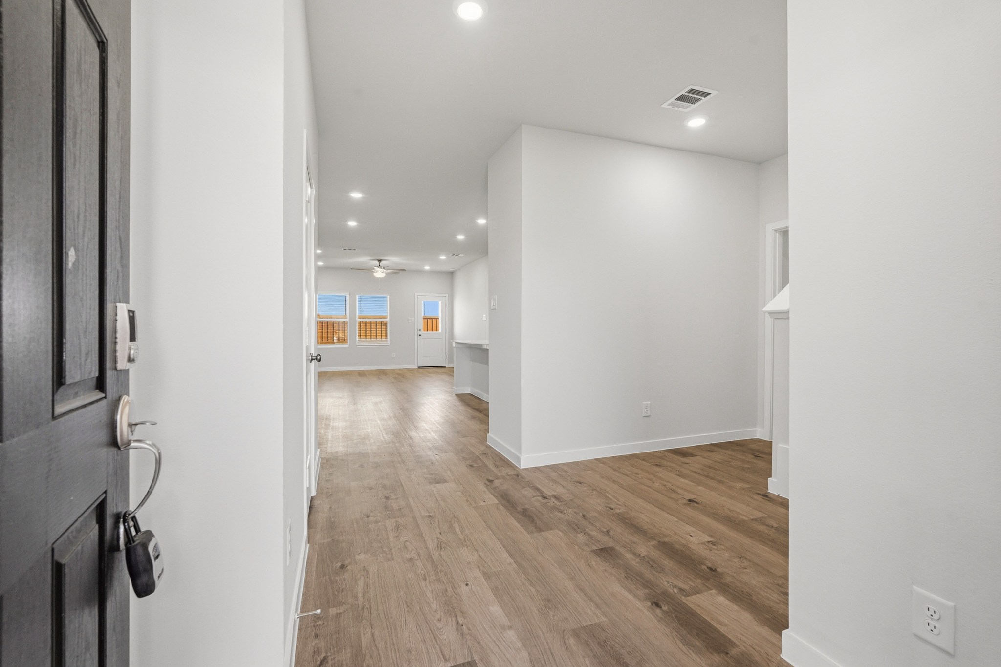 A hallway with white walls.
