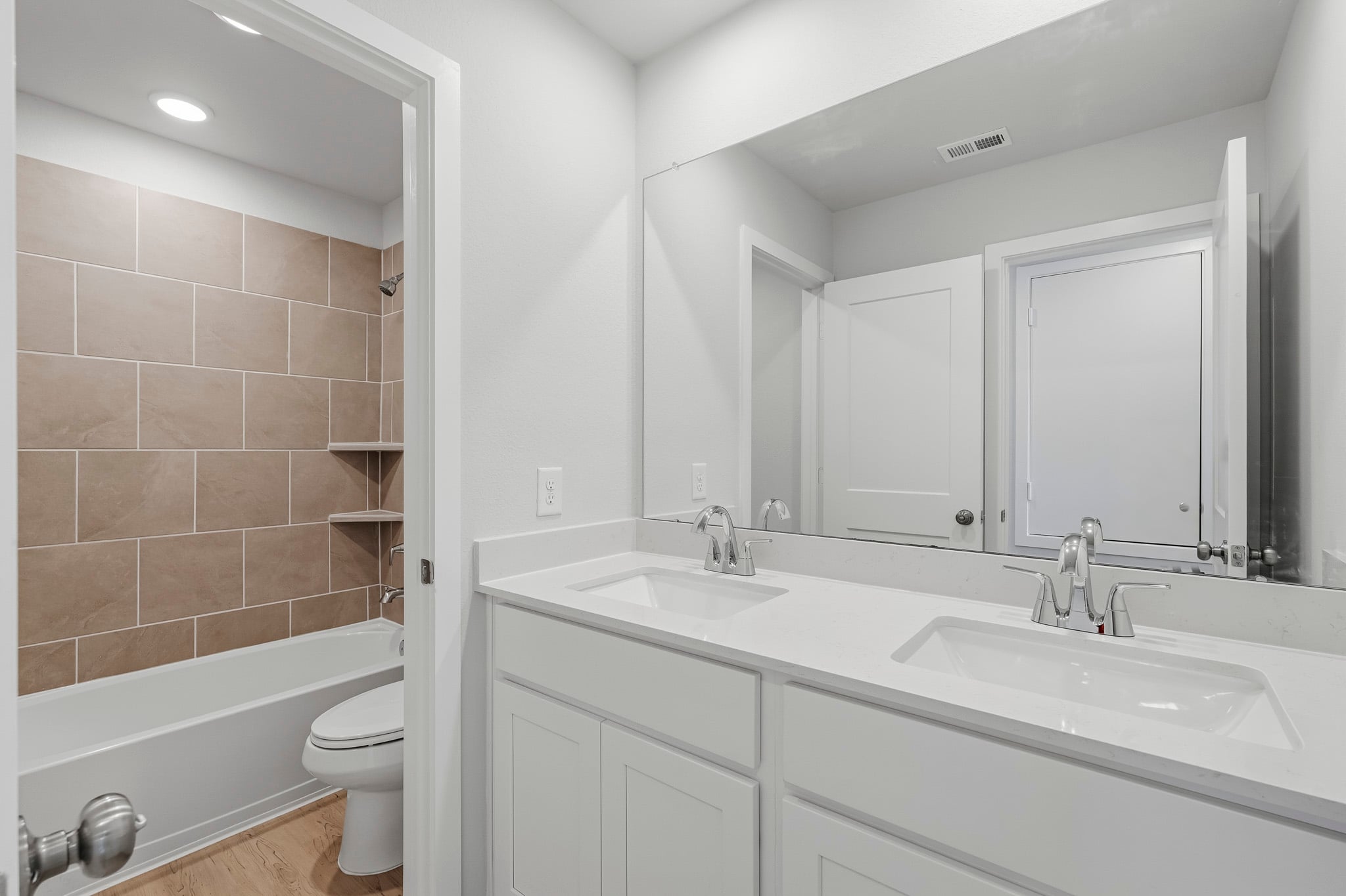A bathroom with a tub sink and toilet.