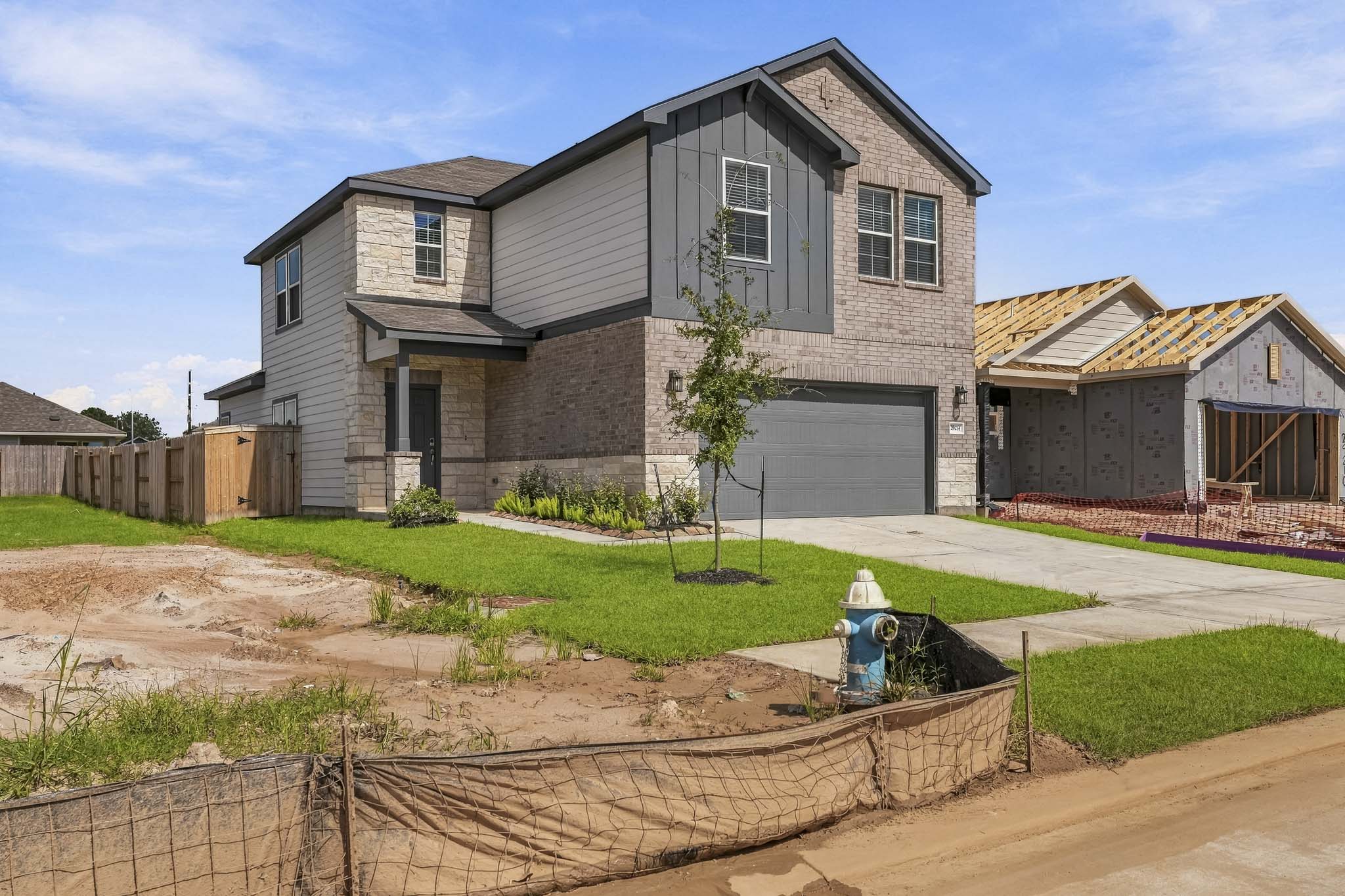 A house with a fence and yard.