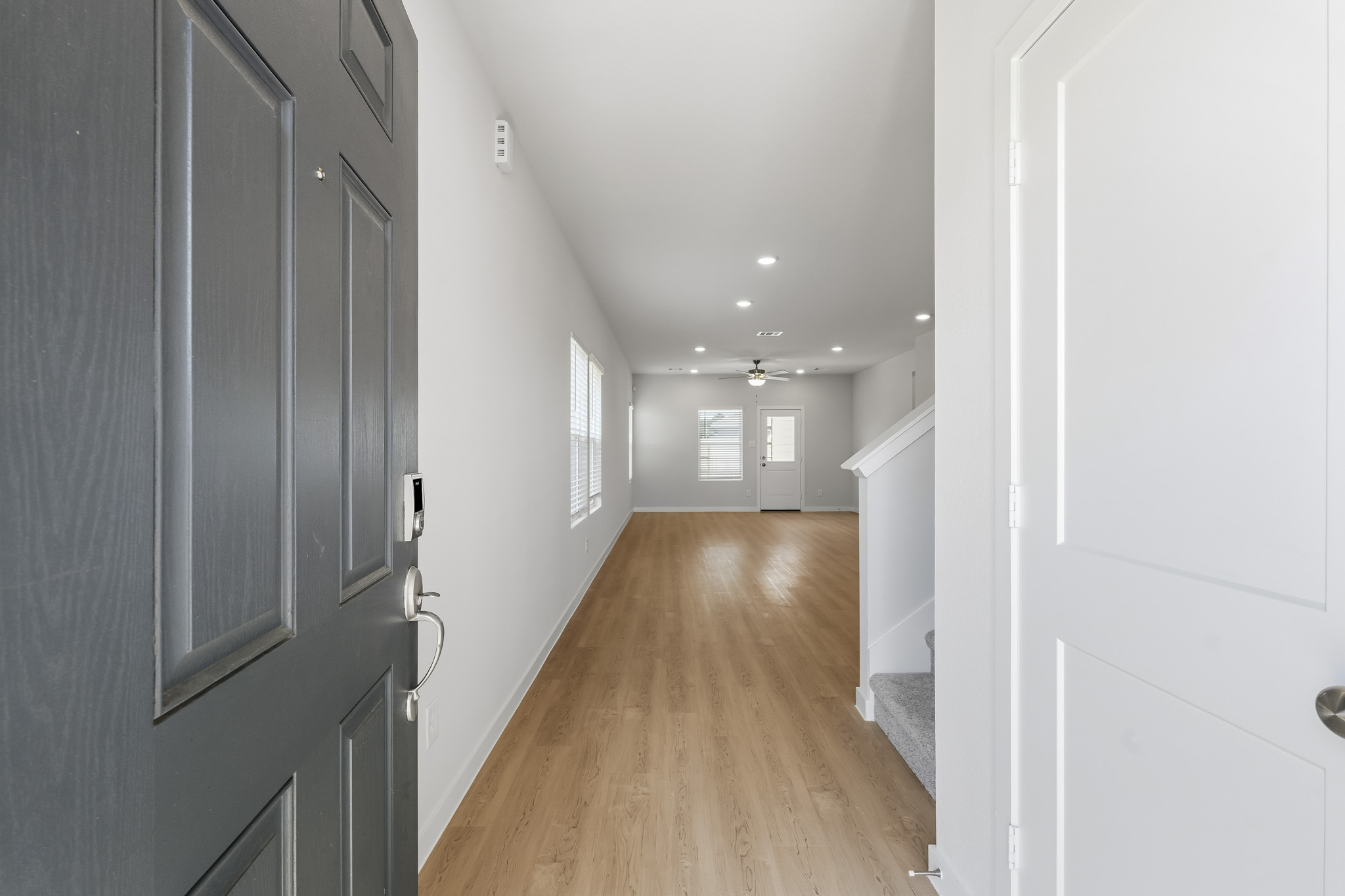 A hallway with white doors.