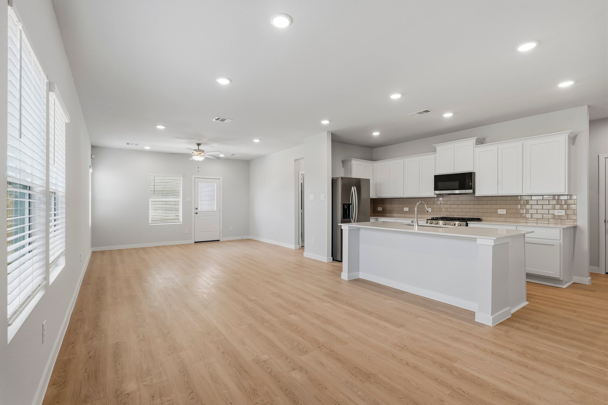 A kitchen with white cabinets.