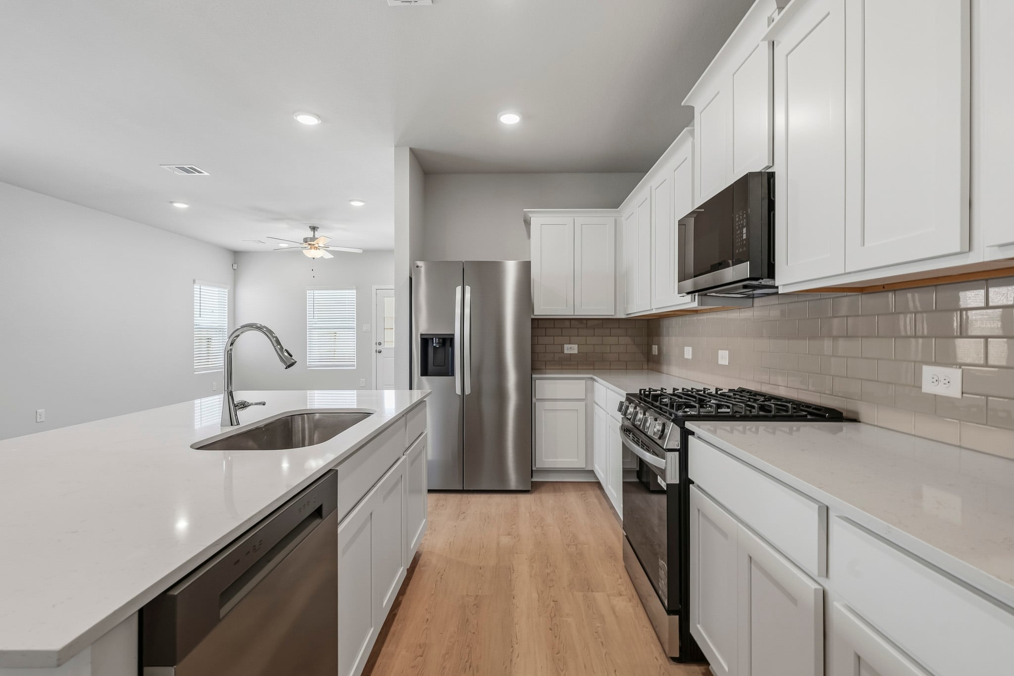 A kitchen with white cabinets.