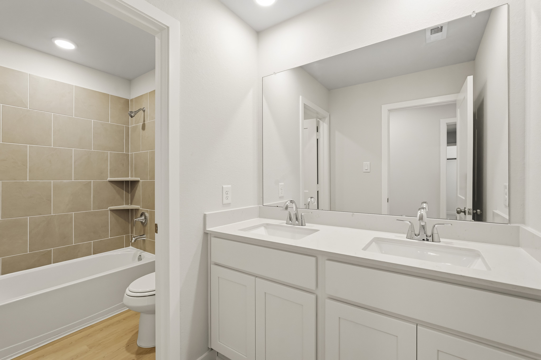 A bathroom with a tub sink and toilet.