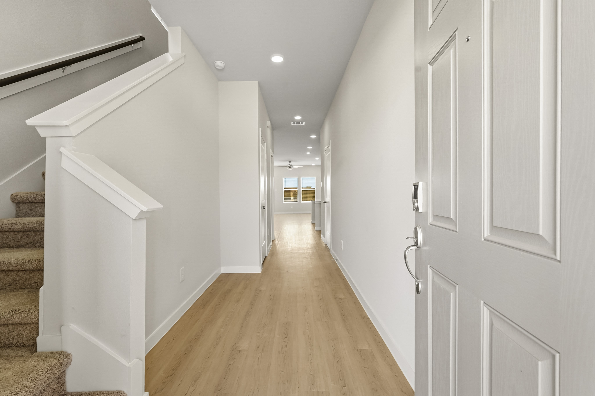 A hallway with white walls.