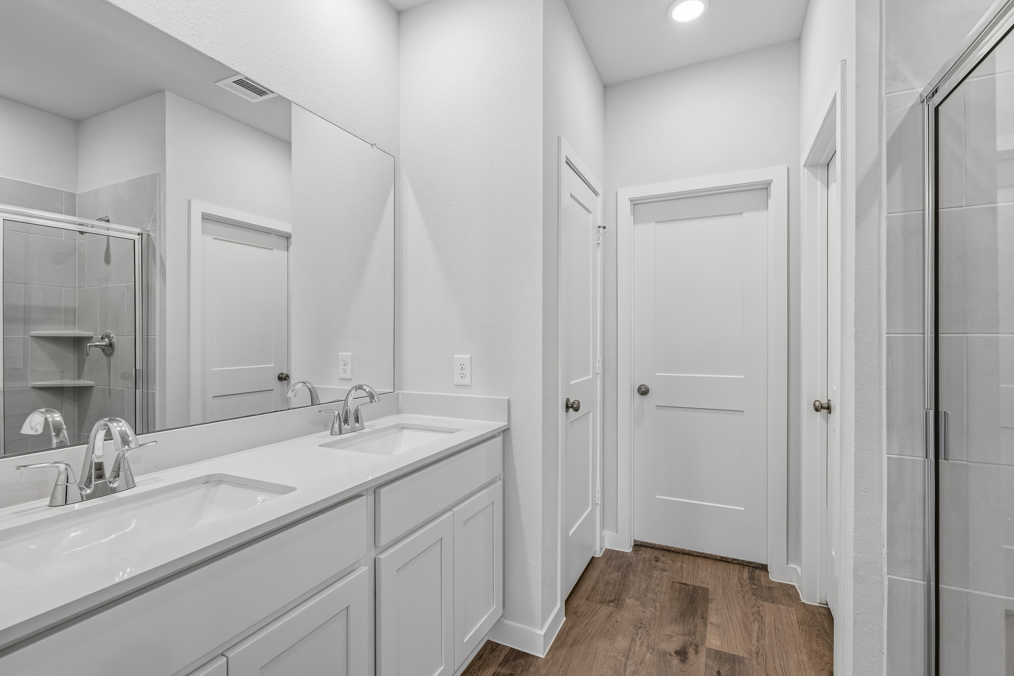 A bathroom with a large mirror.