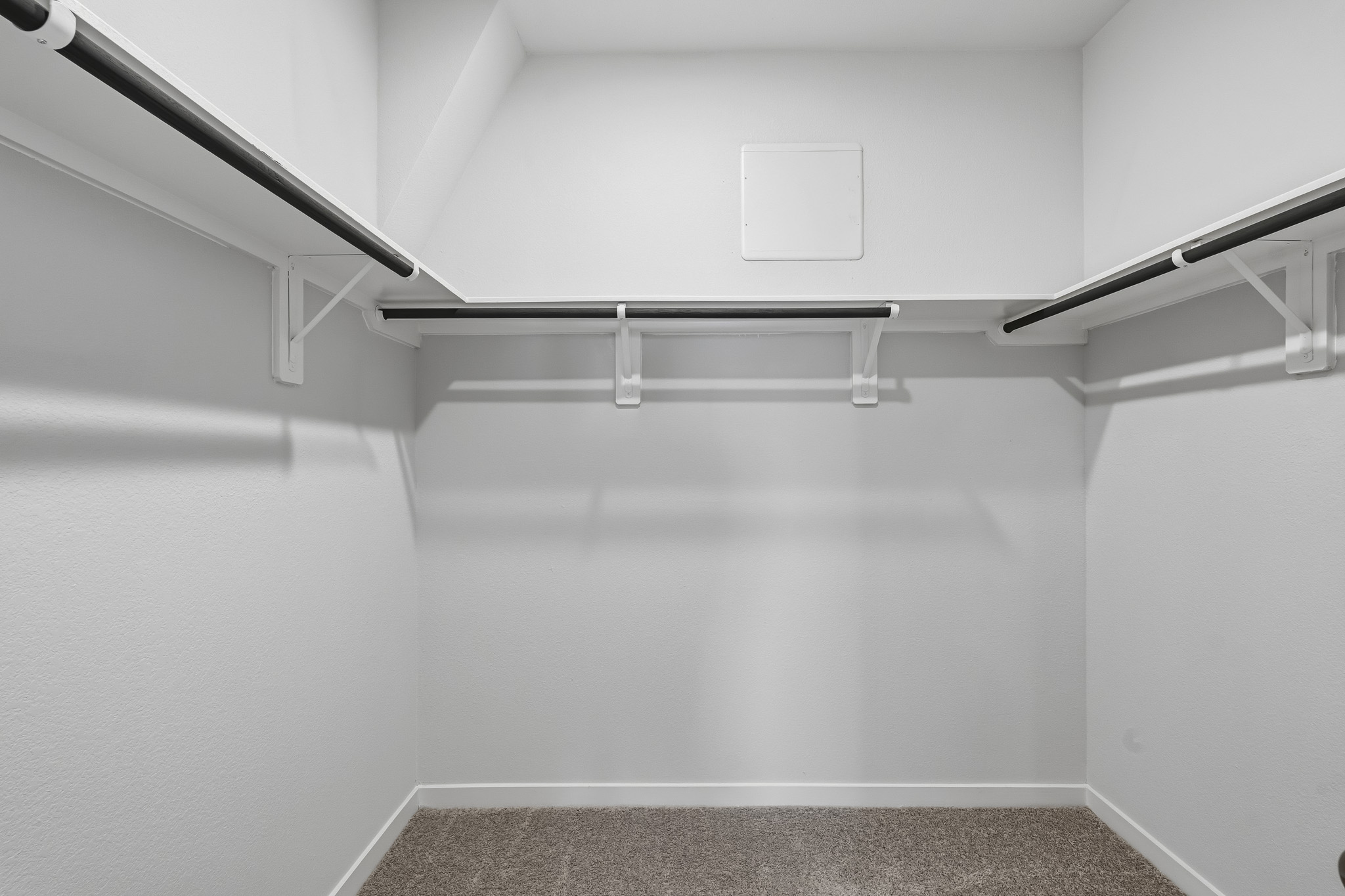 A white staircase with a grey carpet.