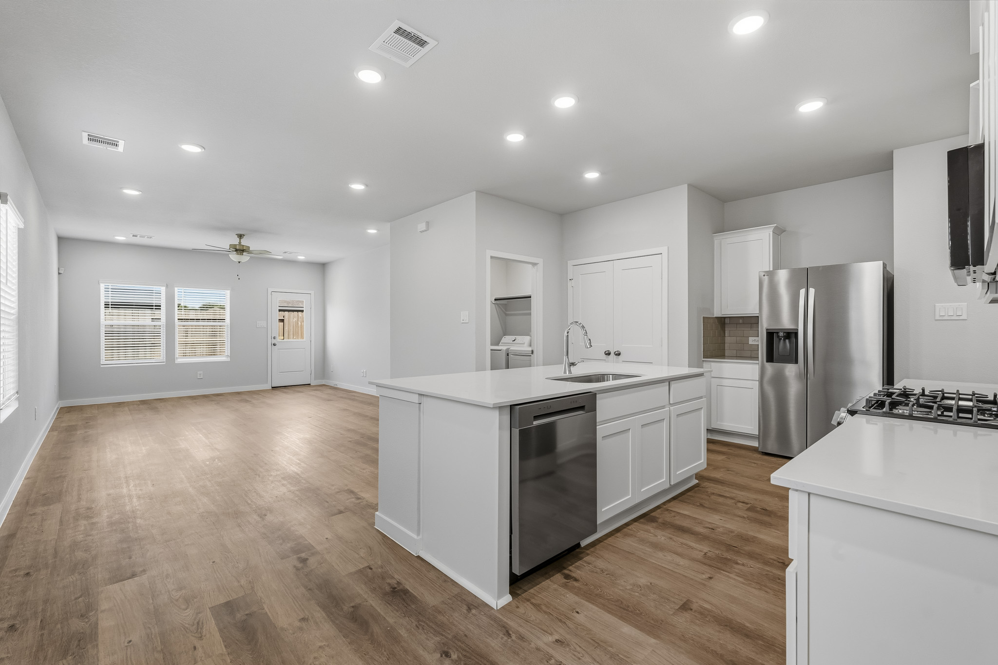 A kitchen with white cabinets.