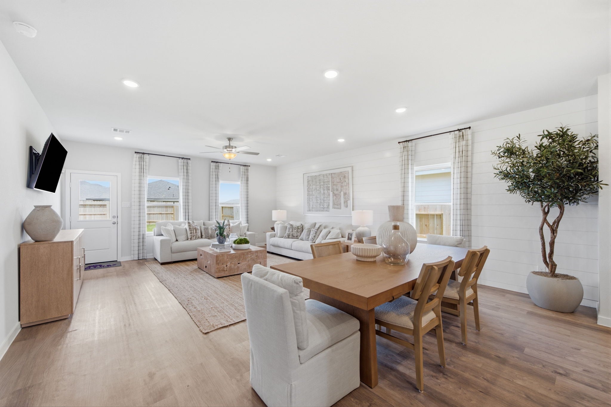 A large living room with a dining table and chairs.