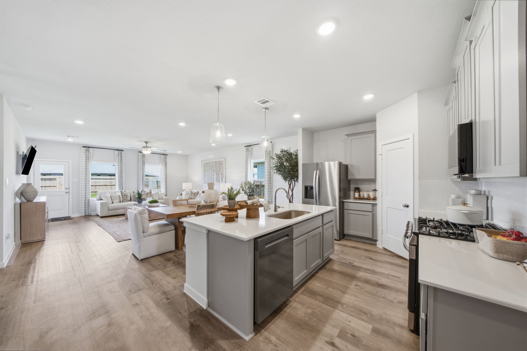 A kitchen with white cabinets.