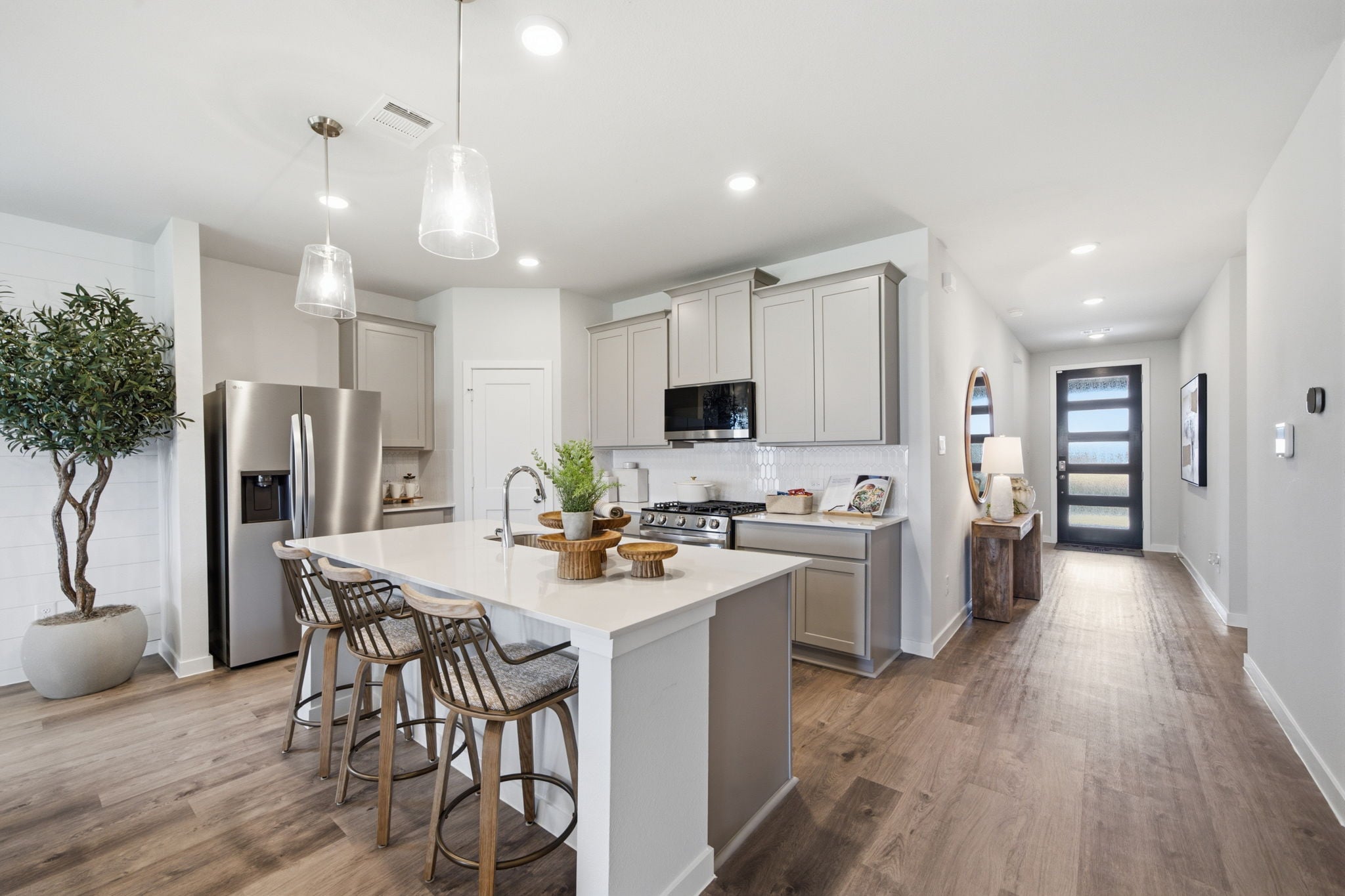 A kitchen with white cabinets.