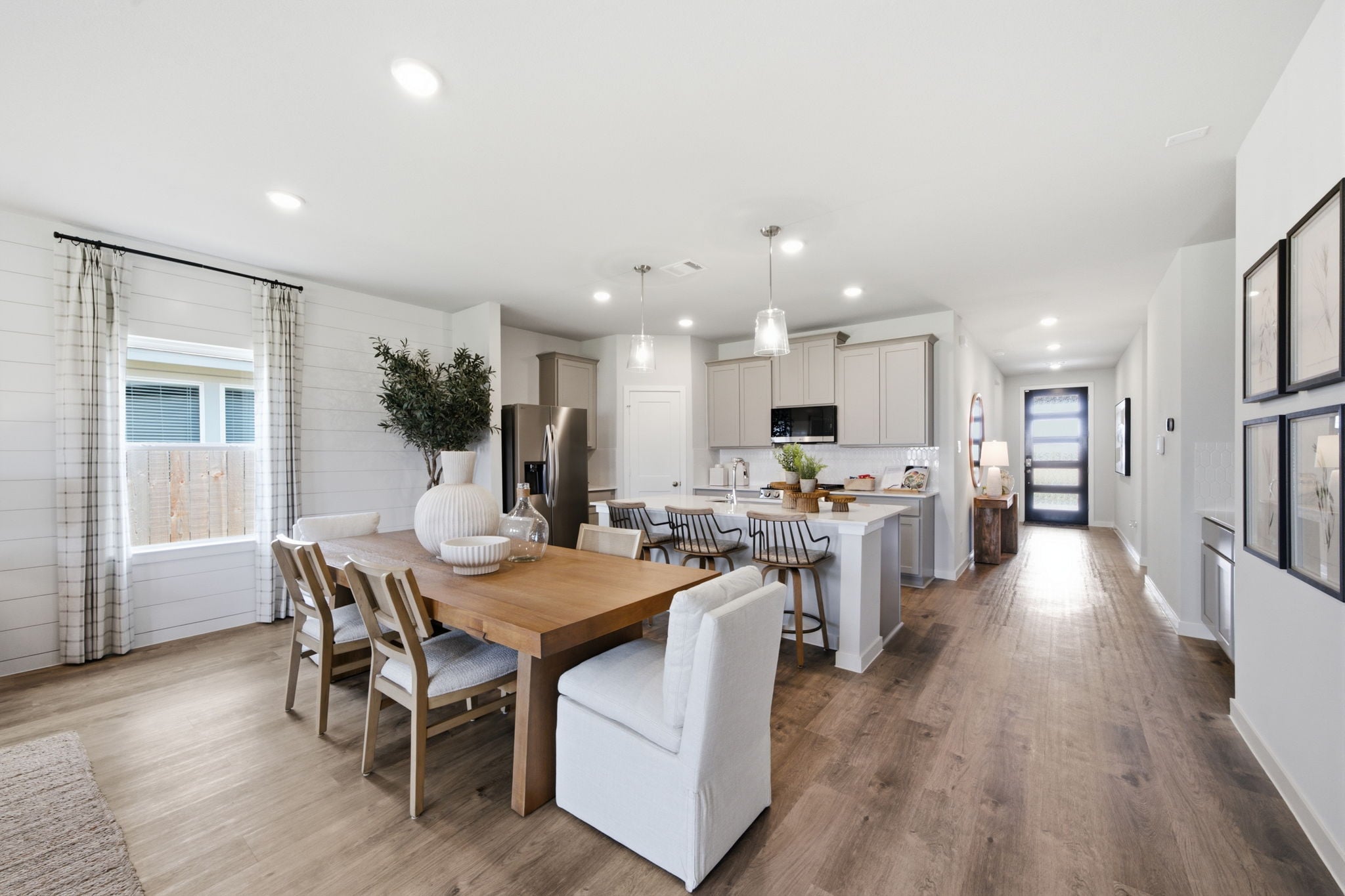 A large kitchen with a dining table.