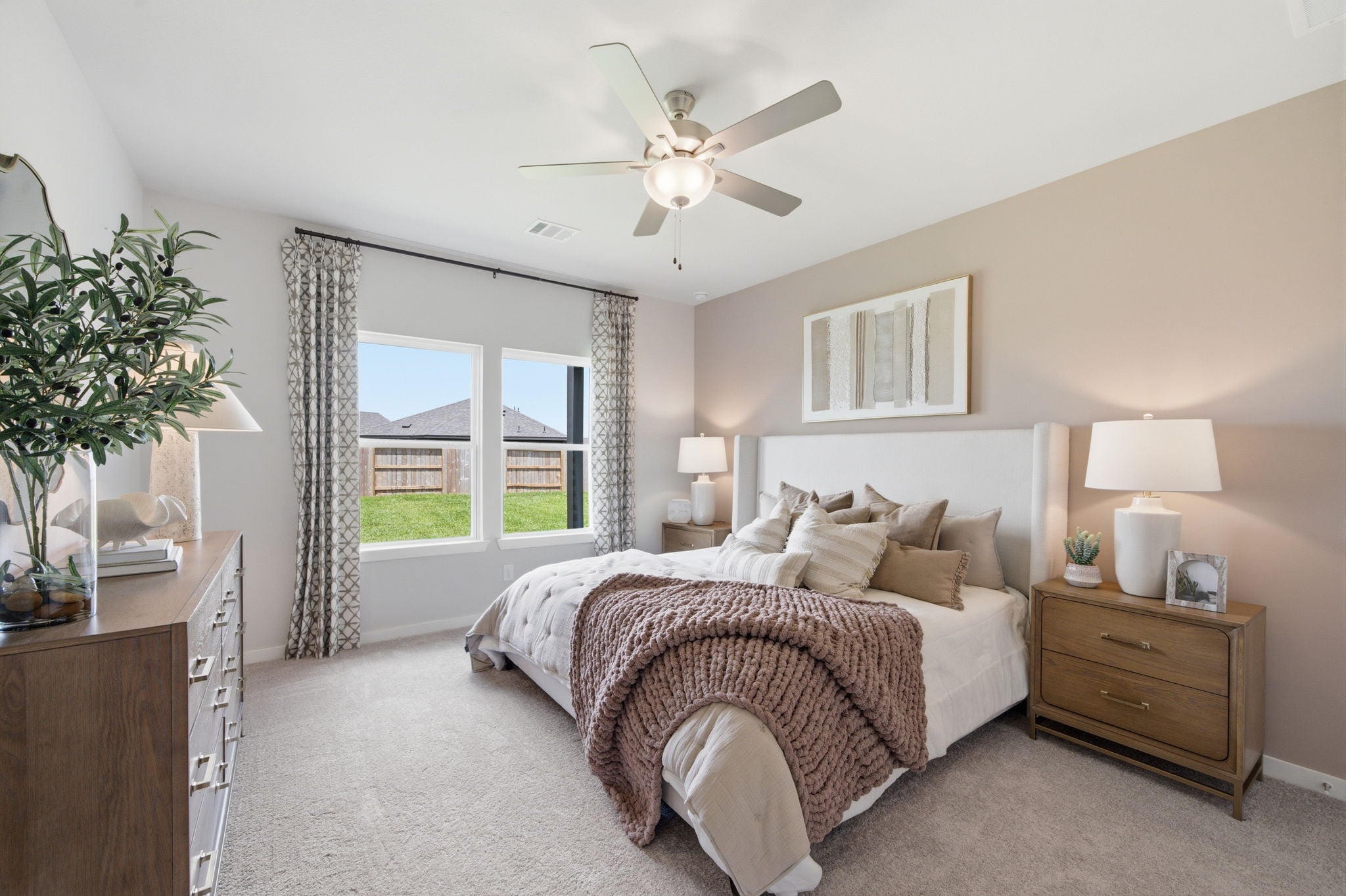 A bedroom with a large window.