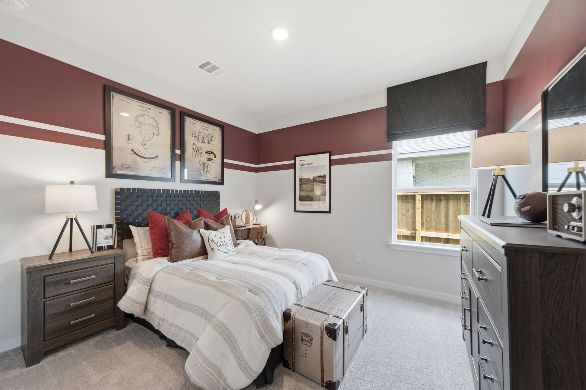 A bedroom with a bed and dresser.