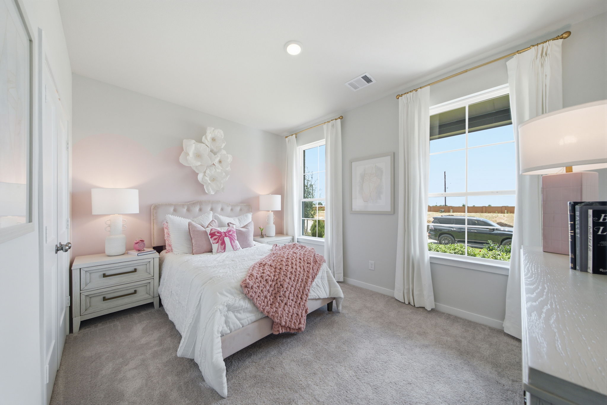 A bedroom with a large window.