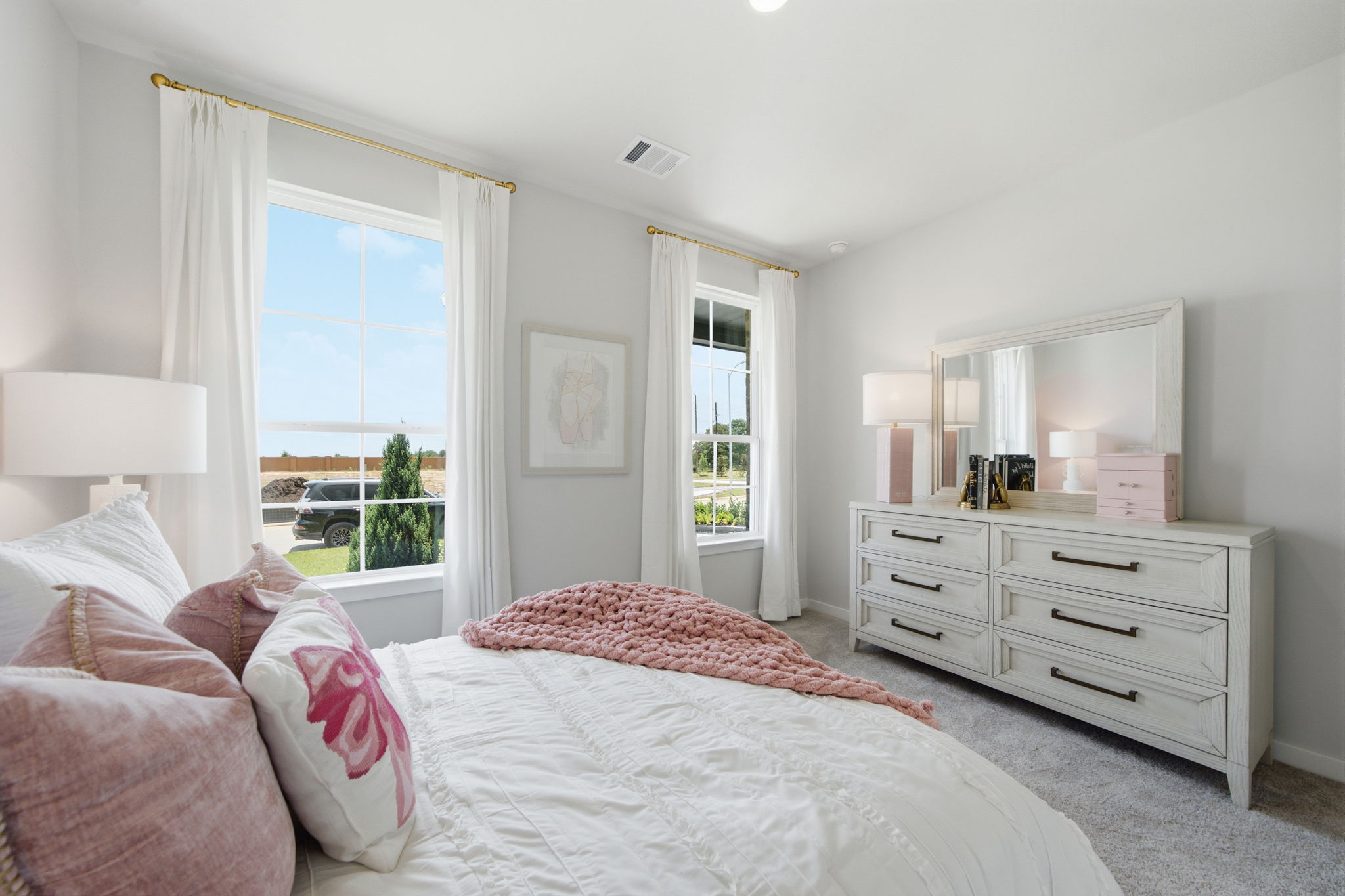 A bedroom with a large window.
