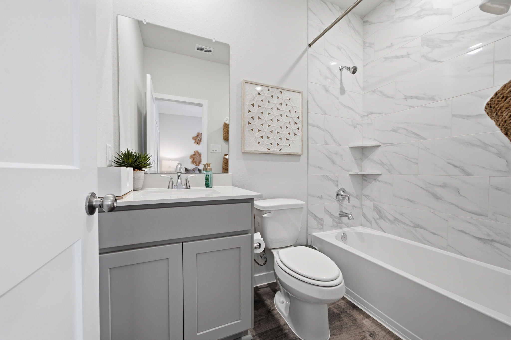 A bathroom with a tub toilet and sink.