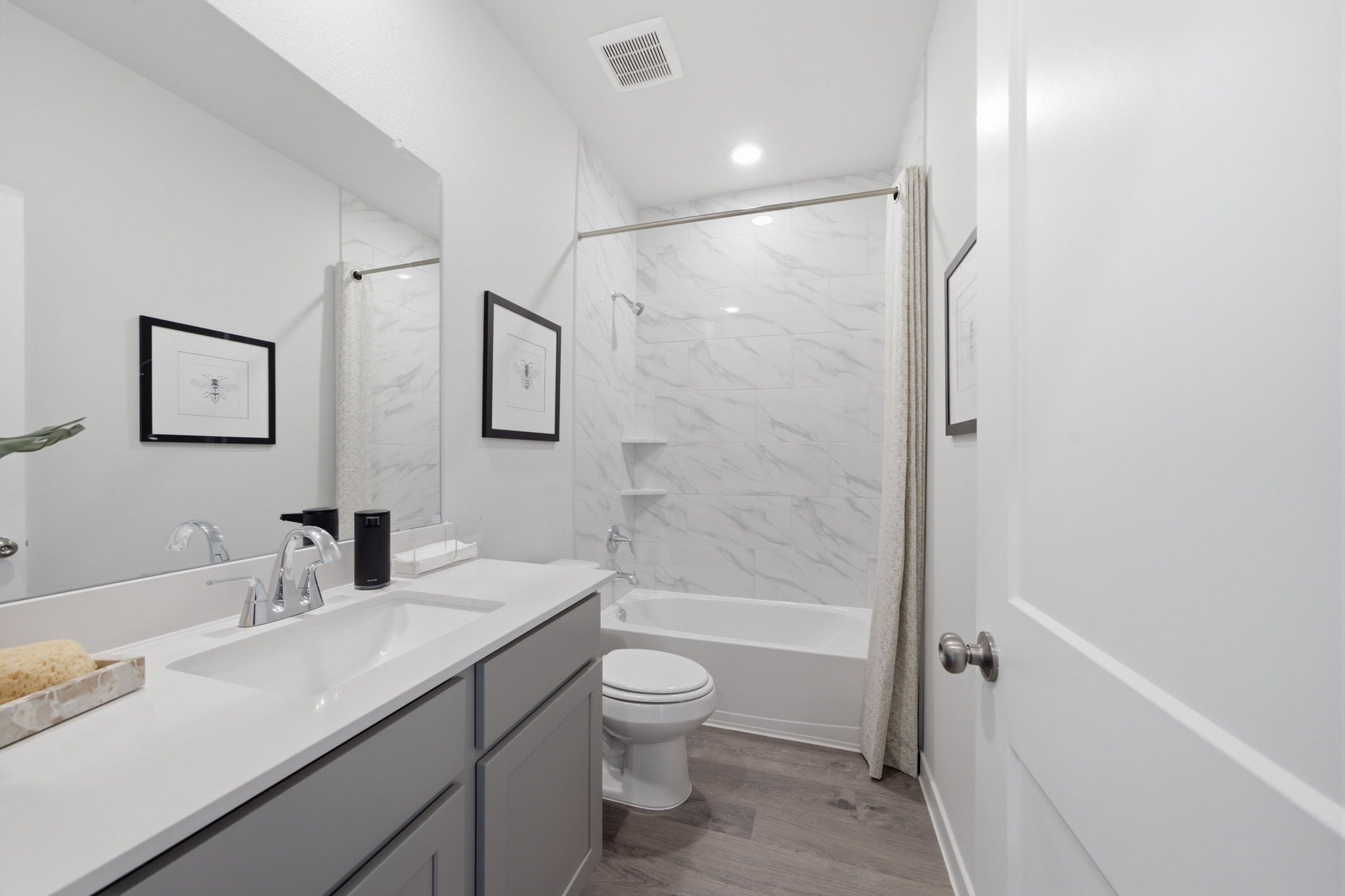 A bathroom with a tub toilet and sink.