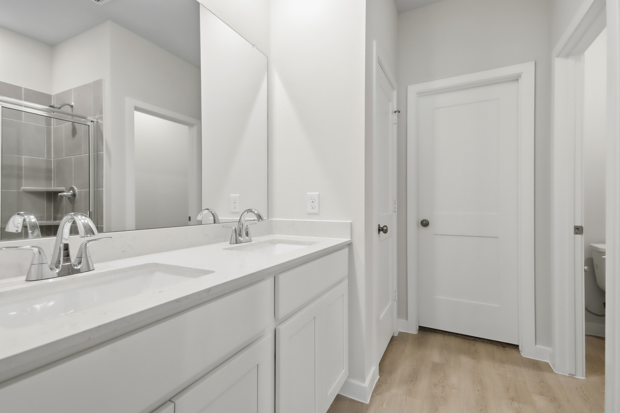 A bathroom with a large mirror.