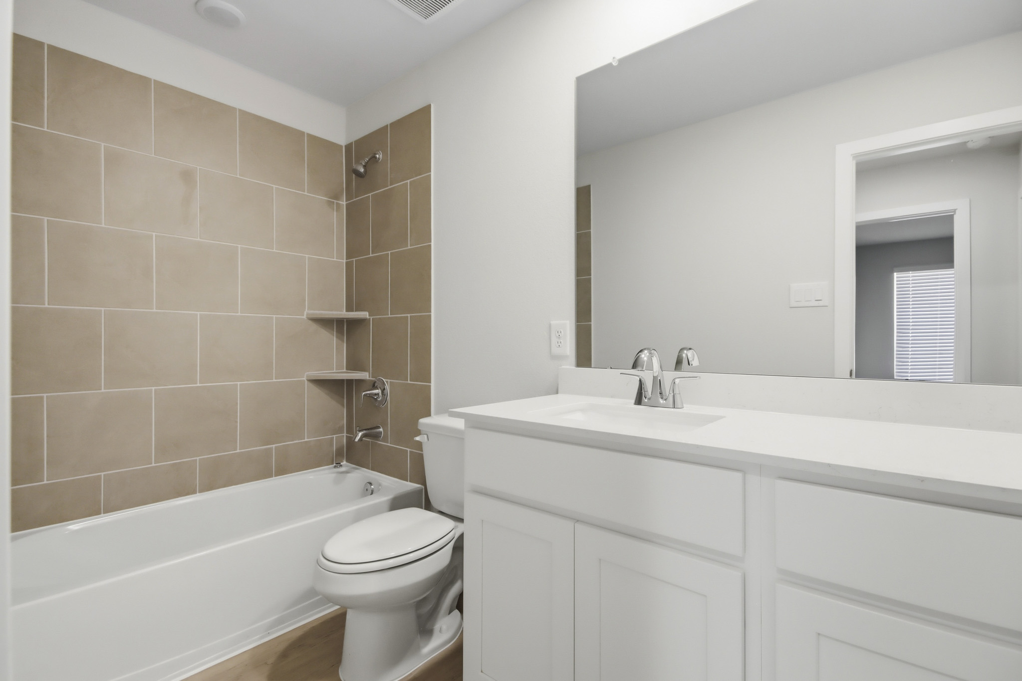 A bathroom with a tub sink and toilet.
