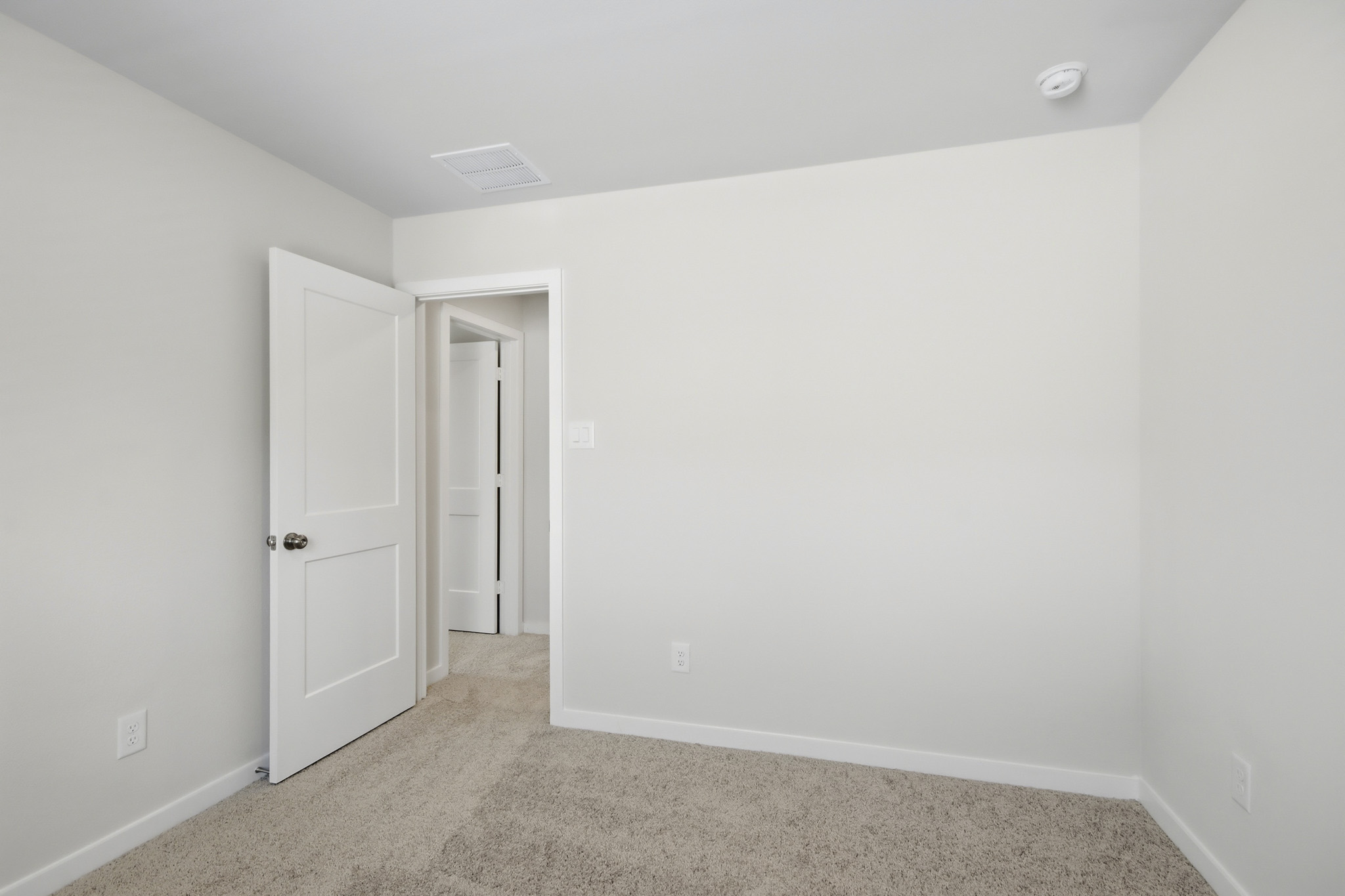 A hallway with white walls.