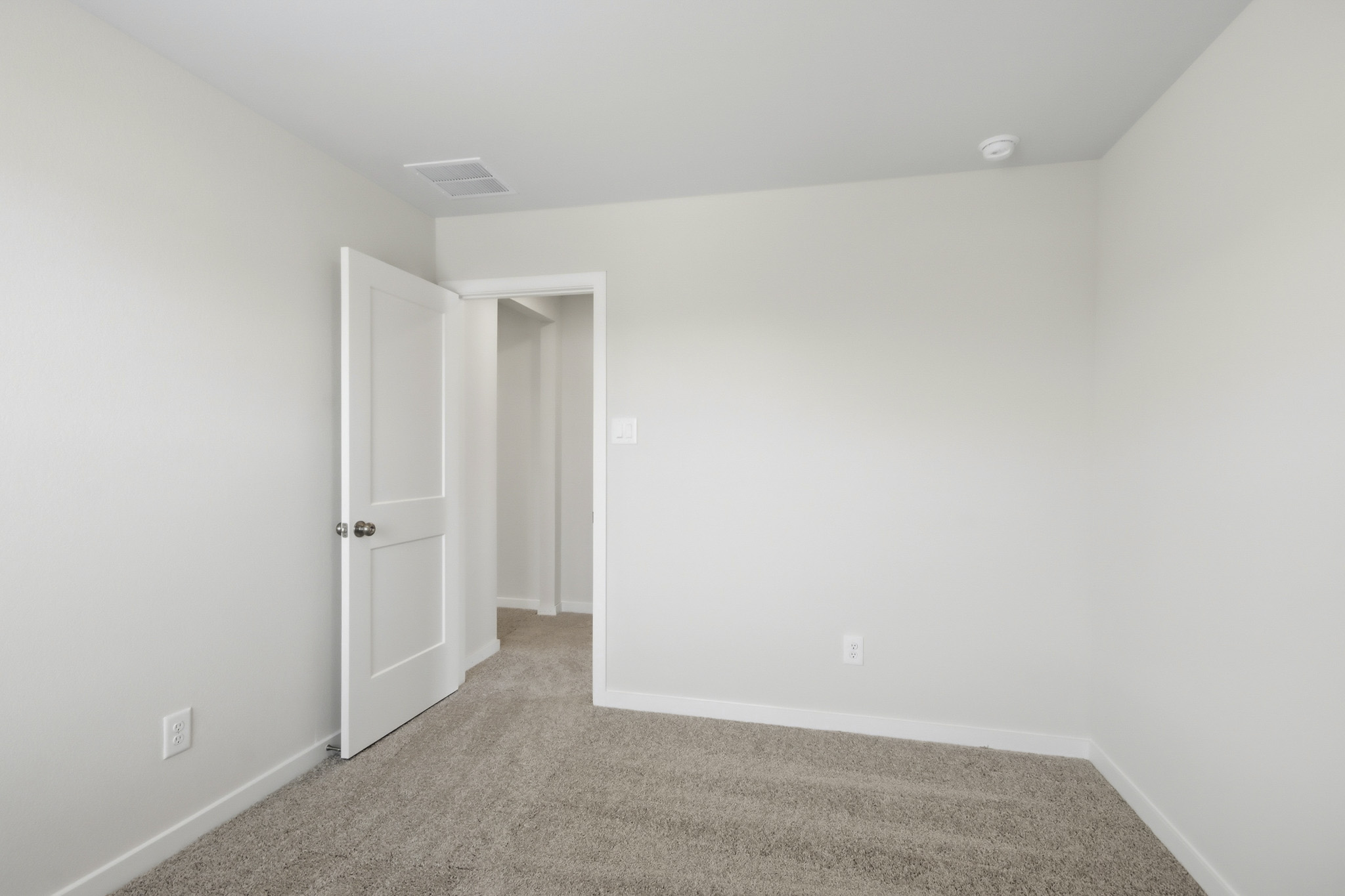 A hallway with white walls.